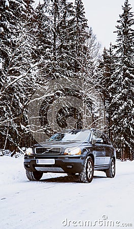 Volvo XC90 SUV stands in the snow covered forest during winter day Editorial Stock Photo