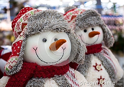 Voronezh, Russia - December 22, 2019: Toys snowmen in winter hats with earflaps and scarves Editorial Stock Photo