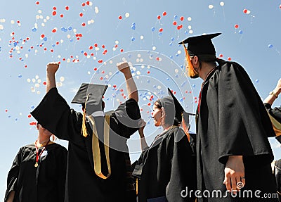 Voronezh, Russia - July 1, 2016: University graduates in black mantles rejoice against the sky and balloons Editorial Stock Photo