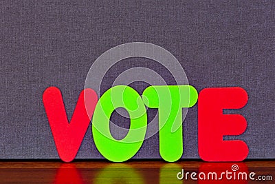 VOTE in colored letters placed on wood against background with copy space Stock Photo