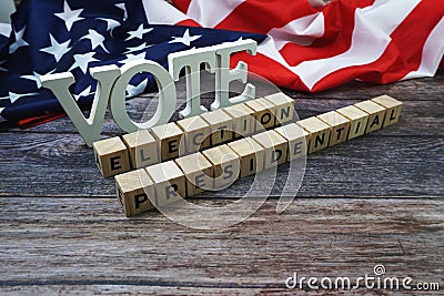 Vote Election Presidential Word alphabet letters with USA flag on wooden background Stock Photo