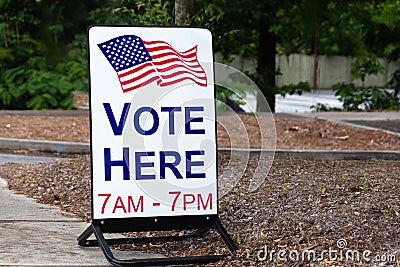 Vote here sign for primaries and elections Stock Photo