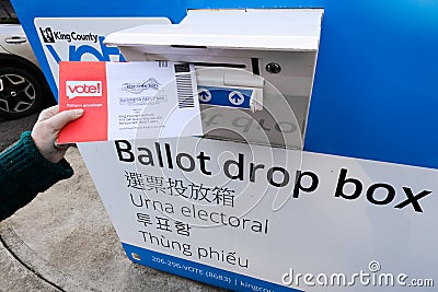 Voter depositing mail-in ballot into curb side drop box Editorial Stock Photo
