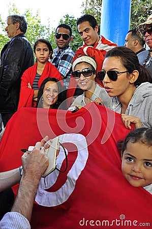 Voters with tunisian red flag waiting to vote Editorial Stock Photo