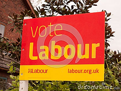 A voting sign outside red and yellow political Editorial Stock Photo