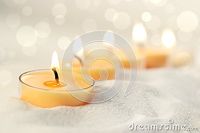 Votive candles in sand Stock Photo