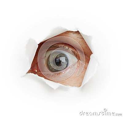 Voyeurism - eye spies through a hole Stock Photo