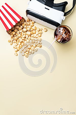 VR goggles between popcorn and cold beverage Stock Photo