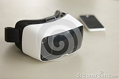 VR headset and smartphone on desk, virtual reality mobile techno Stock Photo
