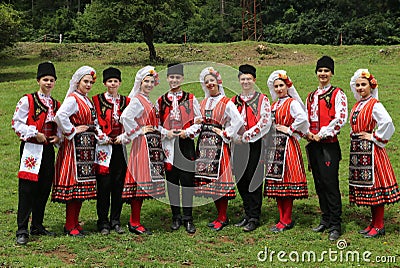 People in traditional authentic folklore costume a meadow near Vratsa, Bulgaria Editorial Stock Photo