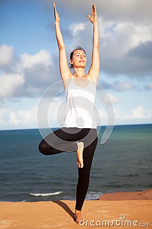 Vrikshasana yoga exercise Stock Photo