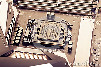 VRM zone, voltage regulator module, CPU socket with protector cap and memory sockets on modern motherboard Stock Photo