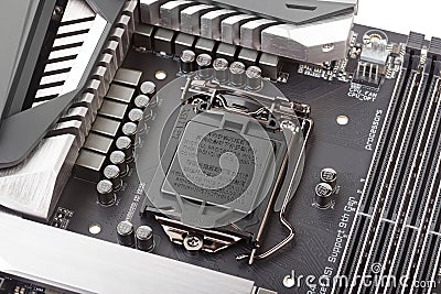 VRM zone Voltage regulator module, CPU socket with protector cap and memory sockets on modern motherboard Editorial Stock Photo