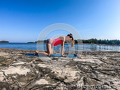 Vrsar - A girl practicing yoga by the seashore Stock Photo