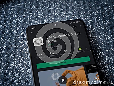 VSCO - Photo and Video Editor app play store page on smartphone on a metallic background Editorial Stock Photo