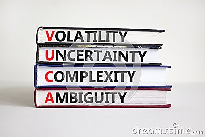 VUCA volatility, uncertainty, complexity, ambiguity symbol. Words `VUCA volatility, uncertainty, complexity, ambiguity` on books Stock Photo