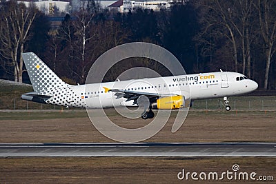 Vueling passenger plane at airport. Schedule flight travel. Aviation and aircraft. Air transport. Global international Editorial Stock Photo