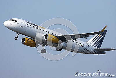 Vueling aiplane flying up in the sky Editorial Stock Photo