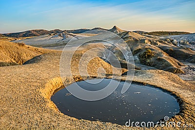 Vulcanii noroiosi Mud Volcanoes Romania lanscape sunset rocky dry landmark Stock Photo