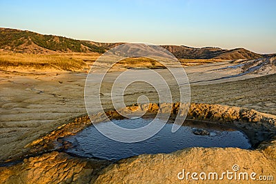 Vulcanii noroiosi Mud Volcanoes Romania lanscape sunset rocky dry landmark Stock Photo