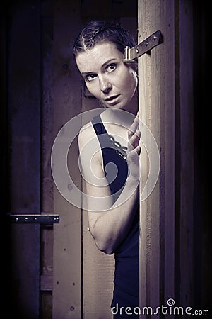 Kidnapped woman in black underwear fighting for escape from basement Stock Photo