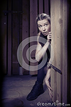 Kidnapped woman in black underwear fighting for escape from basement Stock Photo