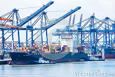 Container terminal with gantry cranes and berthed ships Editorial Stock Photo