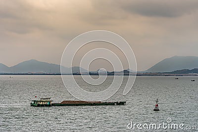 Barge with sand pushed at mouth of Long Tau River, Vung Tau city, Vietnam Stock Photo