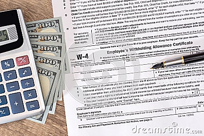 W4 tax form with money and pen Stock Photo