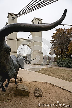 Waco Texas Suspension Bridge Over the Brazos River with Cow Sculpture Editorial Stock Photo