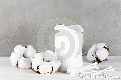 Wadded pads, sticks and cotton flowers on the wooden table Stock Photo