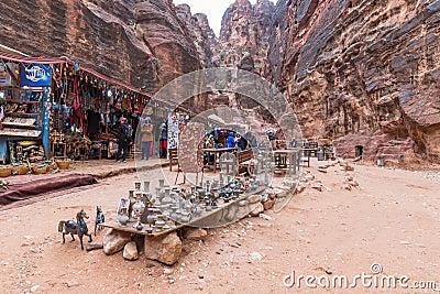 Tourists view souvenirs in Bedouin Petra shop in Petra near Wadi Musa city, Jordan Editorial Stock Photo