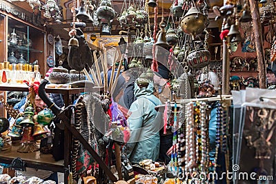 Tourists view souvenirs in a Bedouin shop on the road leading to Petra - the capital of the Nabatean kingdom in Wadi Musa city in Editorial Stock Photo