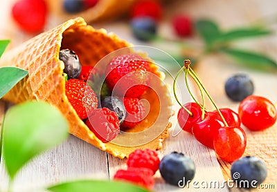 Wafer cups with strawberry, cherry, raspberry and blueberry Stock Photo