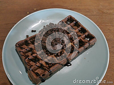 Waffel with chocolate syrup and chocolate ice cream with choco chip Stock Photo