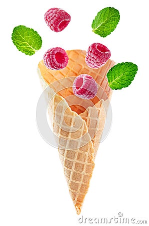 Waffle cones with flying raspberries and mint leaves Stock Photo