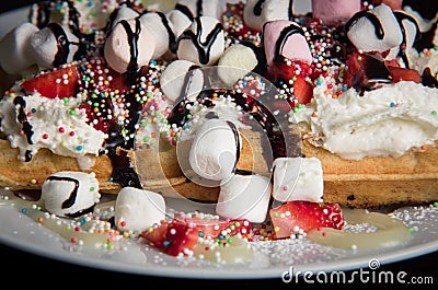 Waffle with marshmallows, whipped cream and strawberry Stock Photo