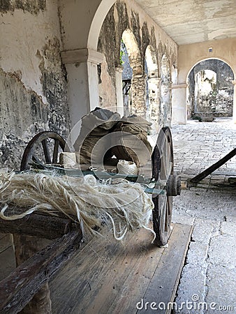 This wagon displays the produce that was once harvested at this abandoned mansion. Stock Photo