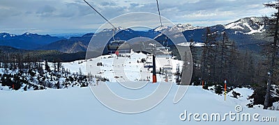 Waidring, Austria - 15.1.2023: View of the chairlift in the Waidring ski resort, Tyrolean Alps, chairs in motion, six-seater Editorial Stock Photo