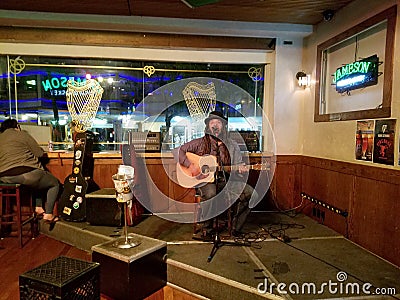 Reggae Musician Keith Batlin sings and plays guitar as he jams Editorial Stock Photo