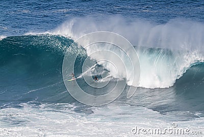 Waimea bay Oahu Hawaii, Surfers ride a big wave Editorial Stock Photo