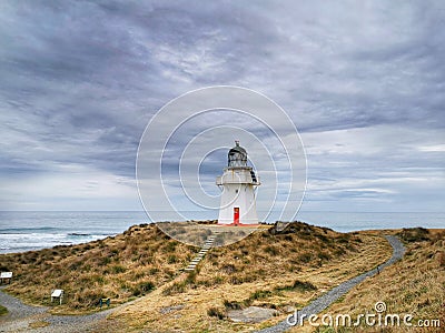 Waipapa Point lighthouse of the Southern Otago region of the South Island of New Zealand under greyish moody sky Stock Photo