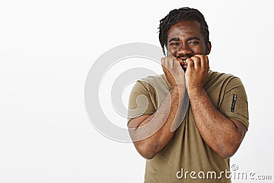 Wais-up shot of impatient good-looking african-american man in military outfit, holding hands on palms and smiling Stock Photo