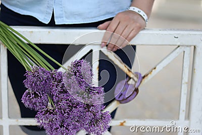 A waist portrait of a woman with a bouquet of wildflowers. Looks into the camera Stock Photo