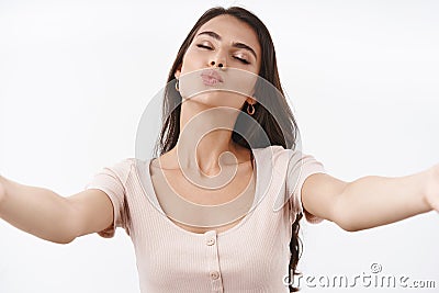 Waist-up portrait lovely, sensual and flirty caucasian woman in dress, stretch hands sideways, reaching for kiss Stock Photo