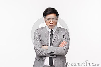 Waist-up portrait of offended and defensive young moody asian male office manager, clerk being upset with coworker prank Stock Photo