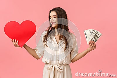 Waist-up portrait surprised and determined brunette woman making her choice towards true love, looking at heart, holding Stock Photo