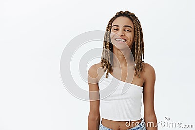 Waist-up shot of charismatic african american girl with dreads in white top smiling assured having fun being confident Stock Photo