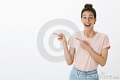 Waist-up shot of happy enthusiastic and excited joyful attractive european female with tan and messy hairbun smiling Stock Photo