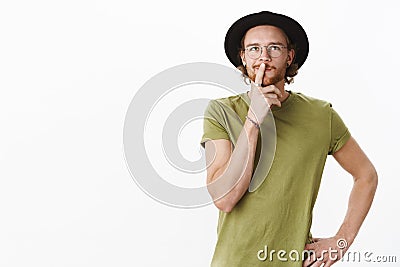 Waist-up shot of man thinking what he desire to eat, chosing restaurant in mind standing in thoughtful hmm pose as Stock Photo